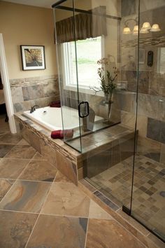 a bathroom with a large tub and tiled floor