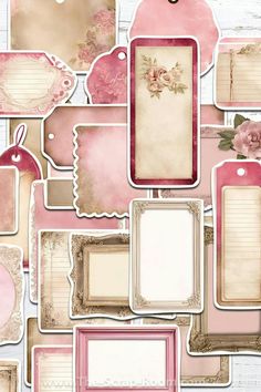 a bunch of pink tags and frames on a white wooden surface with flowers in the middle