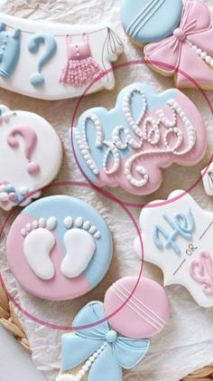 decorated cookies in the shape of baby's feet and footprints on top of a table