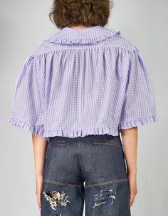 STYLE NOTESA wide and short shirt in lilac-and-white cotton vichy with baby collar, gathered edging along the hems, back gathering under the yoke and front heart-shaped shiny patches in a white satin. The wide short sleeves, featuring gentle folds on the shoulders, and the short length lend a delicate and solid look to the shirt, revealing the childlike nature of the Vipula/Vapula collection. 100% handmade in Italy Loose and unisex fit Hidden buttoning Gathered detail Heart-shaped satin patches White Satin, Short Shirts, White Cotton, Cotton Shirt, Special Occasion, Lilac, Ruffle Blouse, Short Sleeves, Women's Top