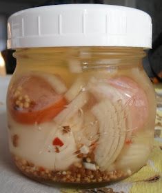 a jar filled with food and sitting on top of a tablecloth covered table cloth