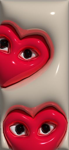 two red hearts with black eyes are shown in this artistic photo, which appears to be made out of plastic