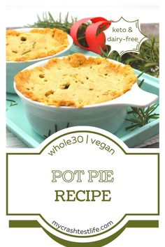 two pies sitting on top of a tray with rosemary sprigs in the background