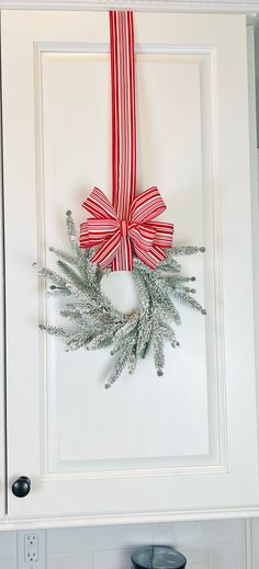 a christmas wreath hanging on the front door