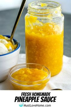 a jar filled with pineapple sauce next to a bowl of ice cream