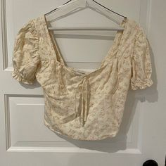 Sweet Floral Crop Top With Bow Detail In Front And Smocking On The Back. Tags Still Attached. Brand New, Never Worn. Side Hidden Zipper Slightly Puffed Short Sleeves Feminine Square Neck Tops For Beach, Fitted Blouse For Vacation By Urban Outfitters, Beige Summer Blouse With Smocked Bodice, Square Neck Blouse For Spring Vacation, Casual Blouse For Brunch By Urban Outfitters, Beige Square Neck Blouse For Spring, Urban Outfitters Fitted Blouse For Vacation, Urban Outfitters Blouse For Spring Vacation, Urban Outfitters Blouse For Vacation In Spring