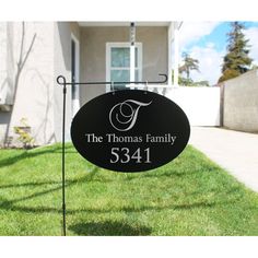 a black and white sign that says the thomas family 5341 in front of a house