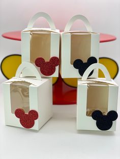 four boxes with mickey mouse ears on them