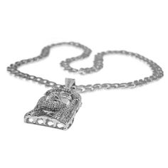 Jesus piece silver tone pendant on a thirty three inch long Cuban link hip hop chain. A dazzling, super chunky Jesus head charm measuring 2.5" inch x 1.5" inch. Pendant features round-cut stones which are encrusted on the crown, beard, hair and eyes. 33" inches long x 15 mm wide, Cuban link chain necklace with a stylish box clasp. Dazzling Jesus pendant and chain necklace set has some weight to it at 280 grams. Enjoy 100% FREE SHIPPING in the USA. Silver Iced Out Pendant Necklace, Silver Cuban Link Jewelry For Streetwear, Silver Chain Link Jewelry For Streetwear, Silver Chain Necklaces For Streetwear, Silver Chain Necklace For Streetwear, Iced Out Metal Pendant Jewelry, Silver Rhinestone Cuban Link Necklace, Silver Cuban Link Necklace With Rhinestones, Silver Cuban Link Chain Necklace With Rhinestones