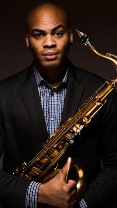 a man holding a saxophone in his hands