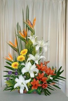 a vase filled with lots of different colored flowers