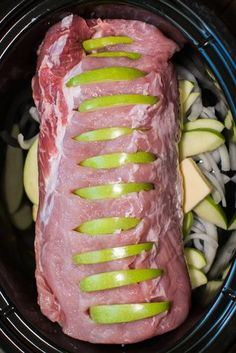 a piece of meat with sliced apples in it