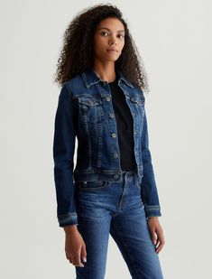 The Robyn Jacket is a slim jean jacket for women featuring a true vintage dark wash with placement shadows, fitted silhouette throughout, and classic chest pockets with tonal button closures. This women’s jacket is designed in a body-hugging 10 oz. Rouge Advanced Stretch Denim—a lightweight, super stretch fabric that lends itself beautifully to light and dark indigo shades.   Rouge Advanced Stretch Denim, 10 Oz. 98% Cotton 2% Spandex Fitted Denim Jacket In Dark Wash With Button Closure, Fitted Denim Jacket With Button Closure In Dark Wash, Fitted Dark Wash Denim Jacket With Button Closure, Classic Fitted Medium Wash Denim Jacket, Fitted Medium Wash Outerwear With Flap Pockets, Fitted Denim Jacket With Flap Pockets For Work, Fitted Denim Jacket With Flap Pockets, Classic Fitted Dark Wash Denim Jacket, Fitted Outerwear With Flap Pockets