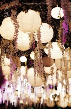 there are many lanterns hanging from the ceiling