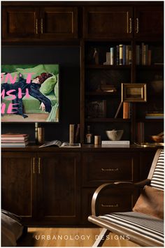 a living room filled with furniture and a flat screen tv mounted on a wall above a wooden entertainment center