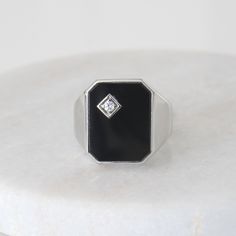 Metal: solid 10k white gold  Gems: genuine rectangle black onyx (15.5 x 12 mm) + round cubic zirconia accent Weight: 6.9 g (approx) Sizes: 8.5 - 11 US (contact us for other size options) Please allow up to 5 business days for processing. Currently only shipping within Canada and the US. | c u r a t e d | Visit our website for curated and modern pieces  https://www.menkduke.com | f a c e b o o k | Follow us on Facebook for new item announcements and discounts  https://www.facebook.com/menkDUKE/ | Formal Sterling Silver Signet Ring With Rectangular Stone, Modern Onyx Signet Ring For Anniversary, Modern Black Enamel Signet Ring For Anniversary, Classic Black Diamond Rings For Formal Occasions, Formal Silver Signet Ring With Rectangular Stone, White Gold Rectangular Signet Ring For Formal Occasions, Modern Diamond Ring With Black Diamonds For Gift, Silver Signet Ring With Rectangular Stone For Formal Occasions, Formal Silver Signet Ring With Black Enamel