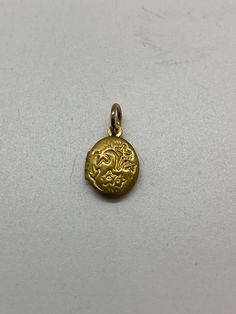 vintage brass locket  this tiny brass locket was made in the 60's, never been worn its deadstock  . very cute floral design embossed on front it sits literally not a half a inch high and 1/4 inches wide  very small. cute cute  thx cml Antique Brass Locket Necklace With Charms, Vintage Etched Oval Pendant Locket Necklace, Antique Gold Locket Necklace With Charms, Gold Antique Locket Necklace With Charms, Vintage Gold Etched Locket Necklace, Antique Engraved Flower Pendant Locket Necklace, Antique Engraved Locket Necklace With Flower Pendant, Gold Vintage Charm Locket Necklace With Flower Pendant, Vintage Charm Oval Pendant Locket Necklace In Brass