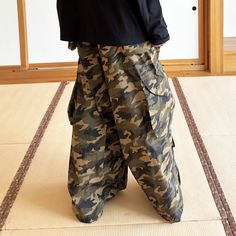 The Camo Wide-Leg Cargo Pants offer the perfect fusion of military-inspired style and casual comfort. Featuring an all-over classic camouflage print, these pants are designed for both functionality and fashion. With practical flap pockets sewn on the sides of the knees, near the hemline, and on the back, these cargos are as functional as they are stylish. Crafted from premium fabric, the oversized fit adds a modern, relaxed feel, making them an ideal choice for everyday wear. Classic camouflage Sneakers And Socks, Half Shirts, Camouflage Print, Jean Accessories, Military Inspired, Short Pants, Jeans Pants, Cargo Pants, Camouflage