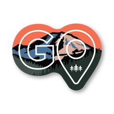 a sticker with the word go on it and mountains in the background, surrounded by trees