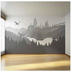 an empty room with a large mural on the wall and wood flooring in front of it