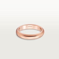 a rose gold ring with the word cartier engraved on it's side, in front of a white background