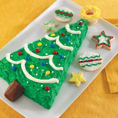 a decorated christmas tree on a plate with cookies