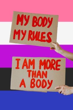 two people holding signs that say, my body my rules i am more than a body