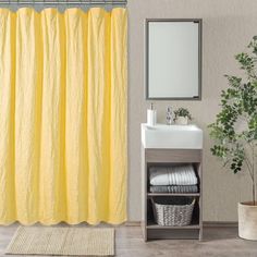 a bathroom with a yellow shower curtain next to a sink