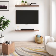 a flat screen tv mounted on the wall above a wooden shelf in a living room