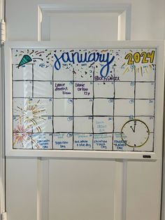 a calendar hanging on a door with the word january written in it and fireworks coming out