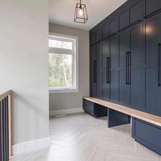 an empty room with blue cabinets and a bench