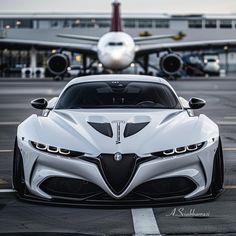 a white sports car parked in front of an airplane