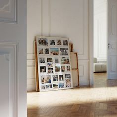 an empty room with pictures on the wall and wood flooring in front of it