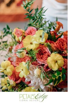 a bridal bouquet with orange and yellow flowers