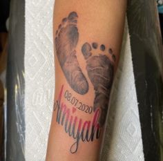 a person with a tattoo on their arm that says, i am my god and the foot is made up of footprints