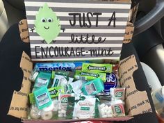 a box filled with lots of candy and toothpaste on top of a car seat