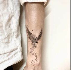 a person with a bird tattoo on their arm