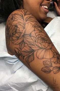 a woman with a flower tattoo on her arm