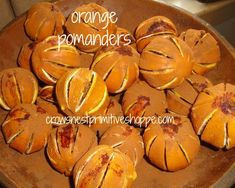 orange buns that have been cut in half and are sitting on a brown plate