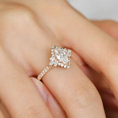 a woman's hand with a diamond ring on it