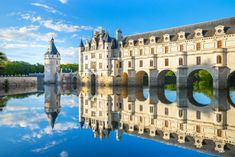 an old castle is reflected in the water