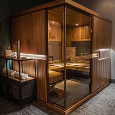 an indoor sauna with wooden walls and flooring