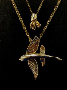 This Flying Fish “In Flight” is a remarkable piece of art, crafted from precious or semi precious alloys upon request including 10K, 14k, 18 K white and yellow gold as well as , .925 Sterling Silver and 935 Argentium (non-tarnish) silver, and set with precious gemstone eye. Like all fish pendants by Nautical Treasure Jewelry, this Flying Fish pendant includes a free leather necklace in the size of your choice. Leather necklaces are available in the sizes 18'', 20", 22", and 24". This pendant is Fish Pendant Gold, Octopus Pendant, Treasure Jewelry, Flying Fish, Fish Necklace, Fish Pendant, Pendant Bails, Tarnished Silver, Nautical Jewelry