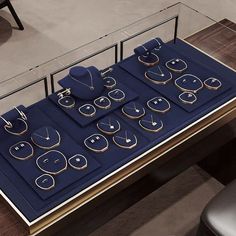 a table that has some kind of jewelry on it with two chairs in front of it