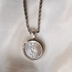 YSL Button Necklace Luxury Silver Medallion Necklace, Luxury Sterling Silver Coin Necklace, Silver Medallion Rope Chain Necklace, Luxury Sterling Silver Coin Necklace With Round Pendant, Classic Necklace With Logo Charm On Round Pendant, Luxury Silver Medallion Pendant Necklace, Classic Necklace With Logo Charm And Round Pendant, Classic Necklace With Round Pendant And Logo Charm, Classic Necklaces With Round Pendant And Logo Charm