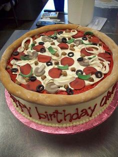 a birthday cake is decorated with red, white and green toppings on a table