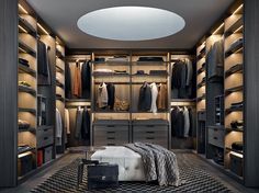 a large walk in closet with lots of clothes