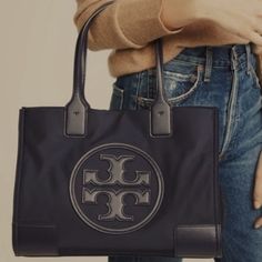 Tory Burch | Black Patent Ella Small Tote Posh Mini Tote That Boasts A High-Shine Exterior And Plenty Of Storage For Your On-The-Go Essentials. Approximate Measurements: 13.6'' W X 10.6'' H X 3.4'' D 7.4'' Handle Drop Patent Leathers Snap Closure Recycled Polyester Two Interior Compartments **In Like New Condition** Snake Purse, Tory Burch Ella Tote, Ella Tote, Tory Burch Ella, Slouchy Tote, Tory Burch Tote, Nylon Tote, Tory Burch Bag, Small Tote