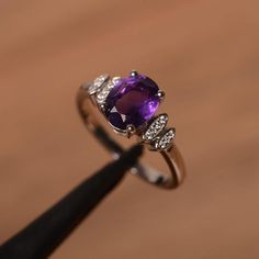 It is natural amethyst ring, the main stone is about 7mm*9mm, oval cut, weight about 1.77 carats.The basic metal is sterling silver and plated with rhodium.To change the metal to a solid gold (white/rose) or platinum is also available, please ask for a quotation if you want.You can also go to my shop Home for more elegant rings: https://www.etsy.com/shop/godjewelry?ref=hdr_shop_menuAmethyst is February birthstone.More amethyst rings:https://www.etsy.com/shop/godjewelry?ref=seller-platform-mcnav& Silver Oval Amethyst Ring With Halo Setting, Silver Amethyst Ring With Oval Accent Stones, Oval Amethyst Ring In Silver, Oval Amethyst Ring In White Gold With Accent Stones, Oval Amethyst Crystal Ring For Anniversary, Purple Oval Crystal Ring For Anniversary, Silver Oval Amethyst Ring, Silver Oval Amethyst Promise Ring, Oval Purple Crystal Ring For Anniversary