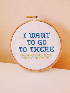 i want to go to there cross - stitch pattern on white fabric with wooden hoop